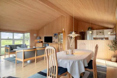 a dining room and kitchen with a table and chairs at 165-Thisted-Laksevej-5 in Thisted