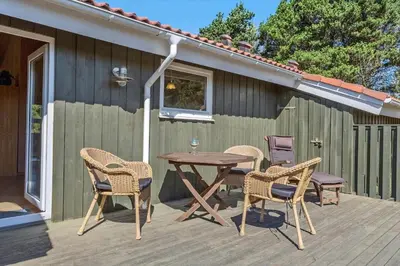 a patio with a table and chairs on a deck at 165-Thisted-Laksevej-5 in Thisted