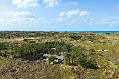an aerial view of a house in a field with the ocean at 1307-Bedsted-Thy-Nordre-Redningsvej-4 in Bedsted Thy
