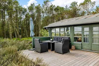 a gazebo with chairs and an umbrella on a deck at 1307-Bedsted-Thy-Nordre-Redningsvej-4 in Bedsted Thy