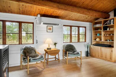 a living room with two chairs and a table at 1307-Bedsted-Thy-Nordre-Redningsvej-4 in Bedsted Thy