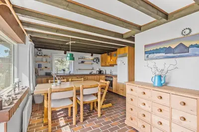 a kitchen with a wooden table and chairs at 641-Snedsted-Istrupvej-21-C in Snedsted