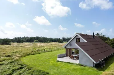 a small house with a brown roof in a field at 641-Snedsted-Istrupvej-21-C in Snedsted
