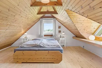 a bed in a room with a wooden ceiling at 641-Snedsted-Istrupvej-21-C in Snedsted