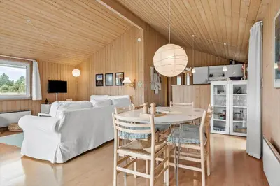 a living room with a table and a couch at 940-Thisted-Spanggardsvej-45 in Torsted