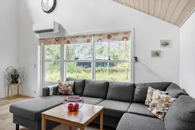 a living room with a gray couch and a table at 669-Thisted-Kristinesvej-68 in Thisted