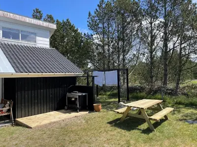 a picnic table and a grill next to a house at 669-Thisted-Kristinesvej-68 in Thisted