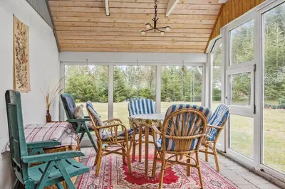 a dining room with chairs and a table and windows at 749-Thisted-Nordsovej-214 in Thisted