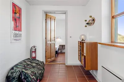 a room with a dog ottoman in front of a door at 917-Thisted-Kobbelsti-46 in Torsted