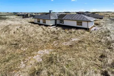 a house with a metal roof on top of a field at 917-Thisted-Kobbelsti-46 in Torsted
