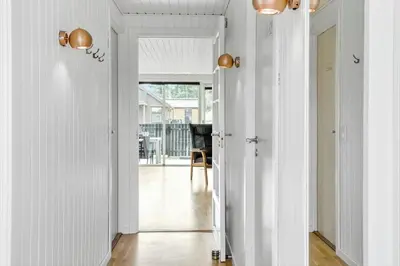 a hallway with white walls and white floors and two lights at 855-Thisted-Flyndervej-5 in Thisted