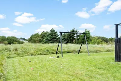 a swing set in the middle of a field at 855-Thisted-Flyndervej-5 in Thisted