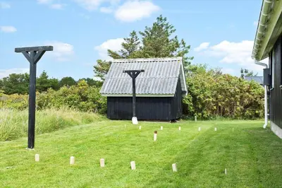 a black building in a yard with a lot of poles at 855-Thisted-Flyndervej-5 in Thisted