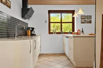 a kitchen with white cabinets and a window at 490-Snedsted-Niels-Juels-Vej-39 in Snedsted