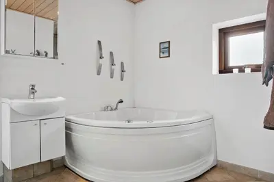 a white bathroom with a tub and a sink at 490-Snedsted-Niels-Juels-Vej-39 in Snedsted