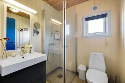 a bathroom with a shower and a toilet and a sink at 1039-Thisted-Niels-Vognmands-Vej-19 in Torsted