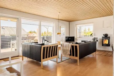 a living room with two couches and a fireplace at 234-Thisted-Kuttervej-9 in Thisted