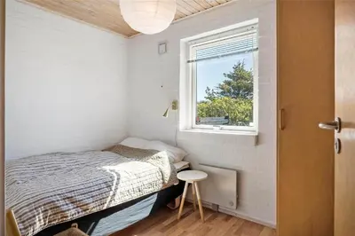 a small bedroom with a bed and a window at 234-Thisted-Kuttervej-9 in Thisted