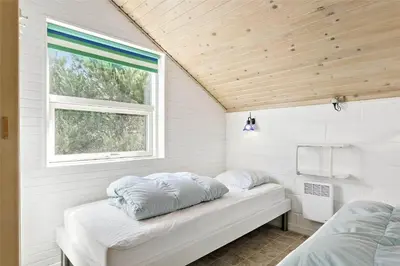 a small room with two beds and a window at 807-Thisted-Grarisvej-13 in Thisted