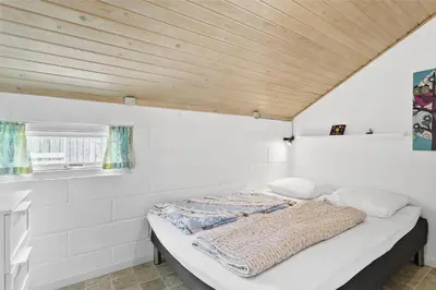 a bed in a room with a wooden ceiling at 807-Thisted-Grarisvej-13 in Thisted