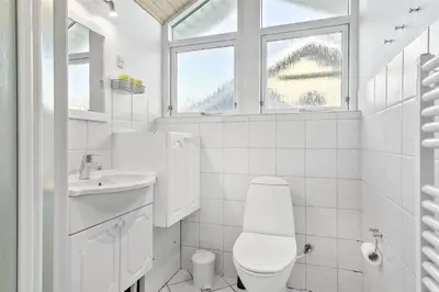 a white bathroom with a toilet and a sink at 807-Thisted-Grarisvej-13 in Thisted