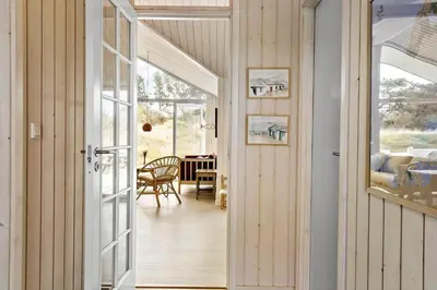 a room with a door leading to a dining room at 192-Snedsted-Sarasvej-12 in Snedsted