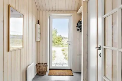 a hallway with a door leading to a yard at 192-Snedsted-Sarasvej-12 in Snedsted