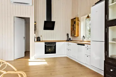 a kitchen with white cabinets and a stove at 192-Snedsted-Sarasvej-12 in Snedsted