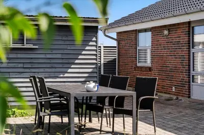 a table and chairs in front of a house at 219-Thisted-Fiskervej-16 in Thisted