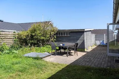 a patio with a table and chairs in a backyard at 219-Thisted-Fiskervej-16 in Thisted