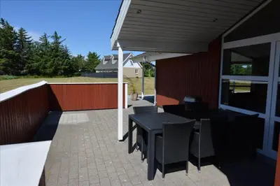 a patio with a black table and chairs at 841-Thisted-Tunvej-7-A in Thisted