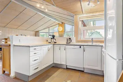 a kitchen with white cabinets and a large window at 841-Thisted-Tunvej-7-A in Thisted