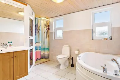 a bathroom with a tub and a toilet and a sink at 841-Thisted-Tunvej-7-A in Thisted