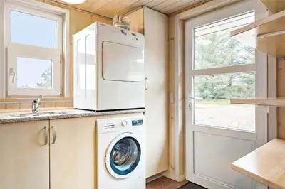 a kitchen with a washing machine and a window at 841-Thisted-Tunvej-7-A in Thisted