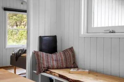 a room with a chair and a bench with a pillow at 931-Thisted-Pinbak-24 in Torsted