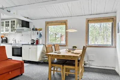 a kitchen with a table and chairs in a room at 645-Thisted-Blabaervej-4 in Thisted