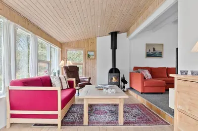 a living room with a red couch and a fireplace at 645-Thisted-Blabaervej-4 in Thisted