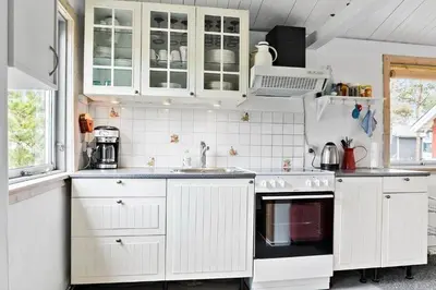 a white kitchen with white cabinets and a sink at 645-Thisted-Blabaervej-4 in Thisted
