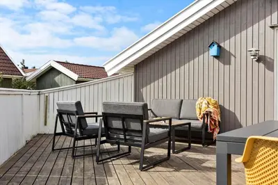 a patio with chairs and a table and a fence at 504-Thisted-Nordsovej-206-C in Thisted