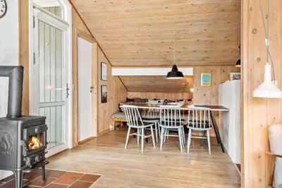 a kitchen and dining room with a wood stove at 504-Thisted-Nordsovej-206-C in Thisted