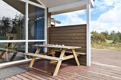 a picnic table on the porch of a house at 916-Thisted-Spanggardsvej-59 in Torsted