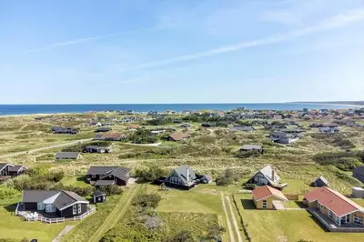 an aerial view of a village with houses and the ocean at 1007-Thisted-Mombak-7 in Torsted