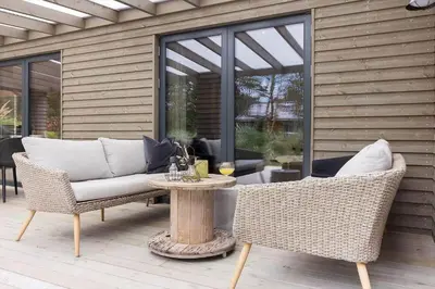 a patio with a couch and chairs and a table at 157-Thisted-Isfuglevej-17 in Thisted