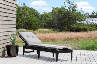 a bench sitting on a patio with a plant at 157-Thisted-Isfuglevej-17 in Thisted