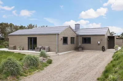 a wooden house with a gravel driveway in front of it at 157-Thisted-Isfuglevej-17 in Thisted