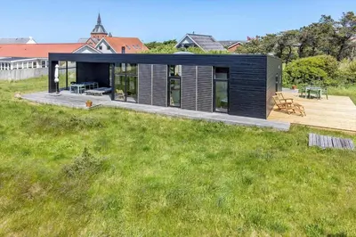 a small black house on a grassy field at 737-Thisted-Bredkaervej-9 in Thisted