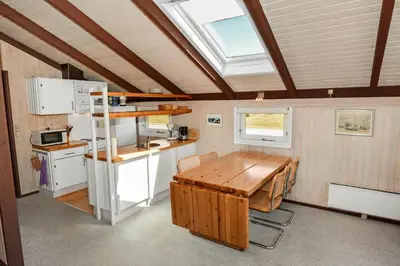 a kitchen with a wooden table in a tiny house at 829-Thisted-Nordsovej-188 in Thisted