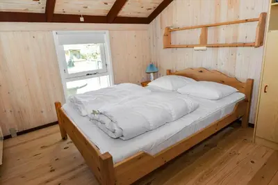 a bedroom with a bed with white sheets and a window at 829-Thisted-Nordsovej-188 in Thisted