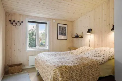 a bedroom with a bed and a window at 1028-Thisted-Tingbakken-28 in Torsted