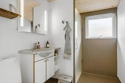 a bathroom with a sink and a shower at 1028-Thisted-Tingbakken-28 in Torsted
